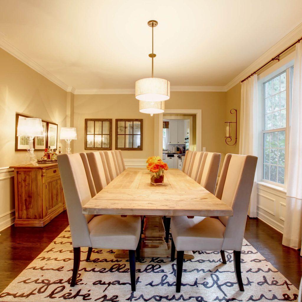 Area Rug Buying Guide: Sizes, Materials & Expert Tips 6 Dining room with a rectangular area rug placed under a wooden table and upholstered chairs